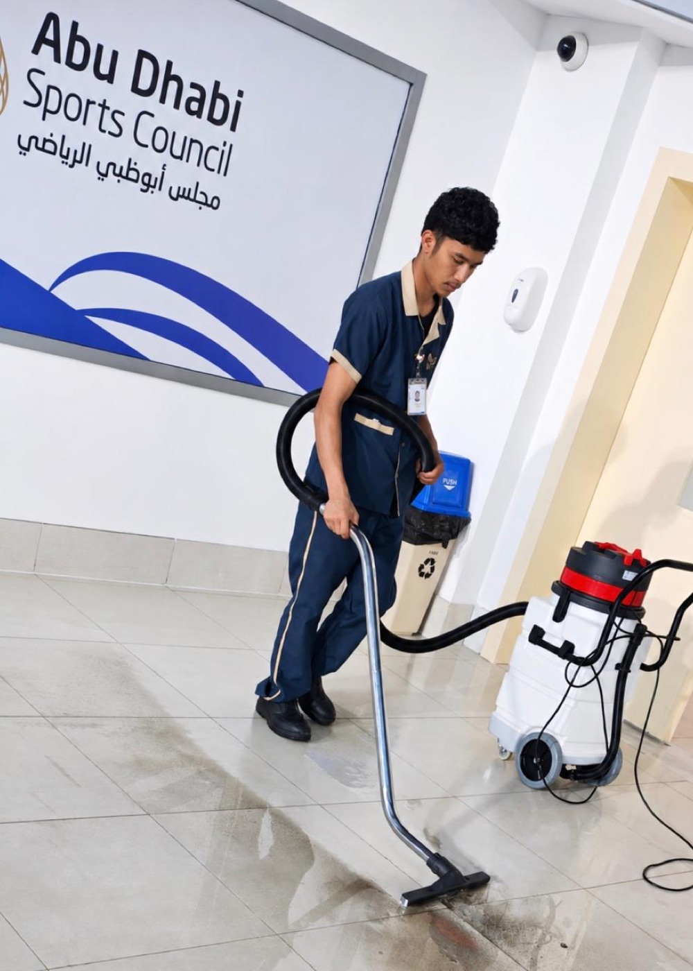 La Marquise team member deep-cleaning floors at Abu Dhabi Sports Council