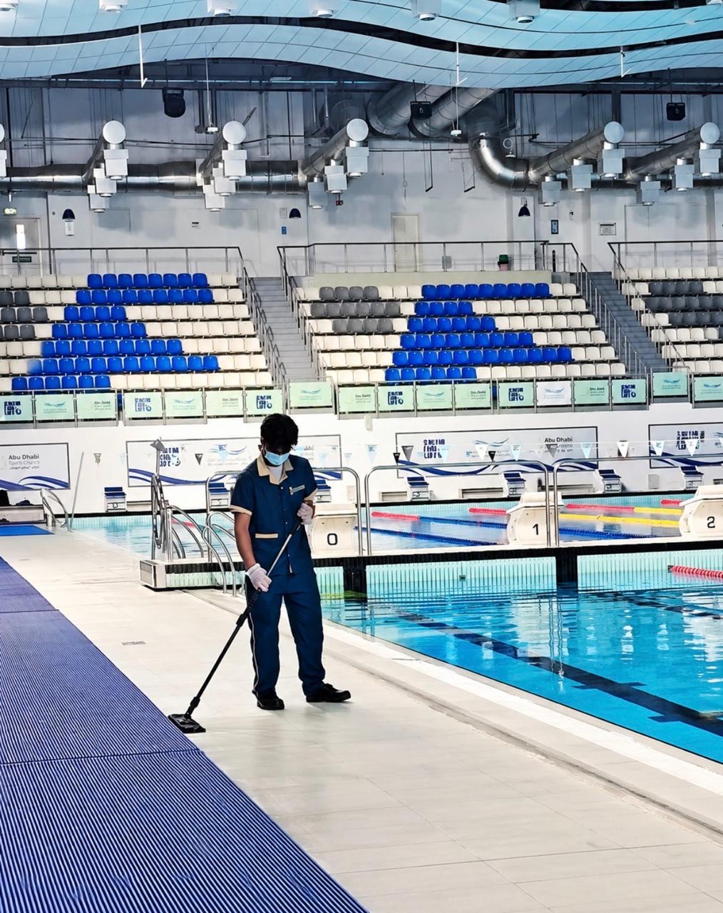 La Marquise technician maintaining the pool deck at a competition swimming facility